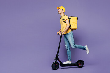 Full body side profile view young delivery guy employee man he wears yellow cap t-shirt uniform workwear thermal bag work as dealer courier ride e-scooter isolated on plain pastel purple background.