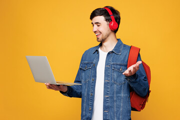 Young boy student wear casual clothes headphones backpack bag hold use work on laptop pc computer...