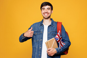 Young smiling clever English boy student he wears denim casual clothes backpack bag hold books...