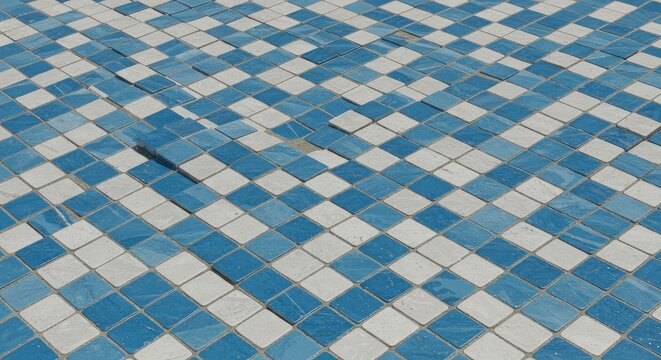 A damaged mosaic floor pattern with cracks and missing tiles