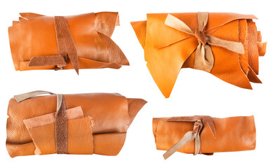 Isolated genuine leather rolls, leather pieces for craft, sewing, patchwork. Brown and orange...