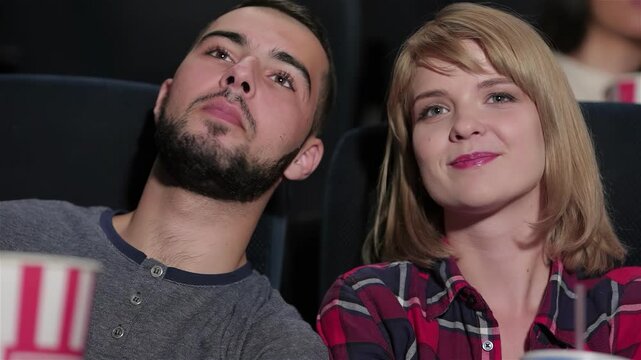 Enthusiastic couple enjoying a movie night in a multiplex theater