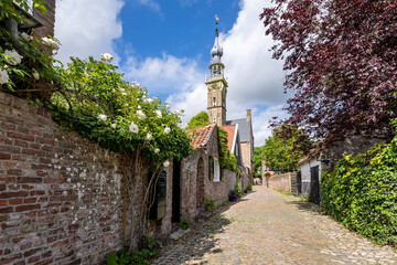 picturesque cobblestone alley to the town hall in Veere, Zeeland, Netherlands