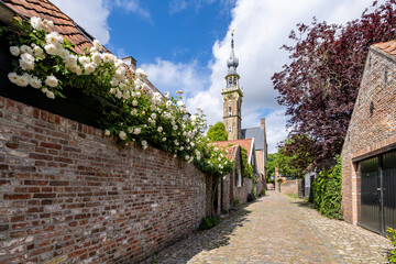 picturesque cobblestone alley to the town hall in Veere, Zeeland, Netherlands