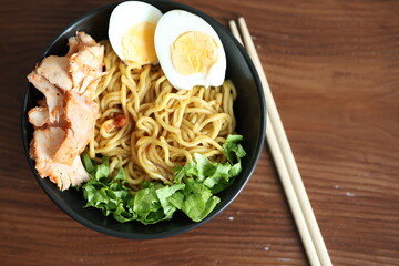 Japanese ramen with egg on black bowl in close-up