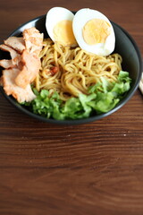 Japanese ramen with egg on black bowl in close-up