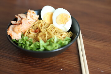 Japanese ramen with egg on black bowl in close-up