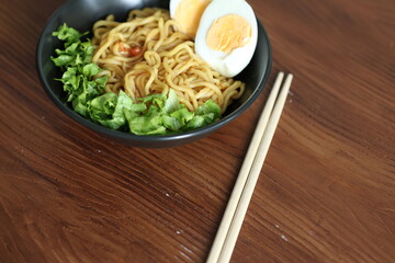 Japanese ramen with egg on black bowl in close-up