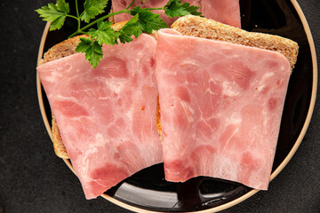 Sandwich ham slices meat spam pork fresh gourmet food background on the table rustic food top view...