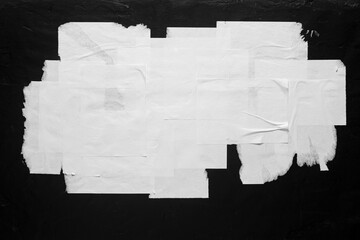 Torn posters on a notice board.