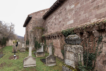 Old church with cemetery and stone crosses in countryside