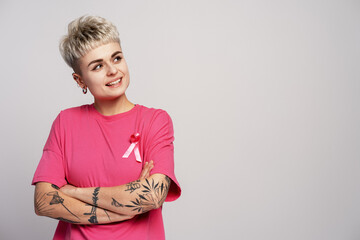 Young woman with pink ribbon supporting breast cancer awareness