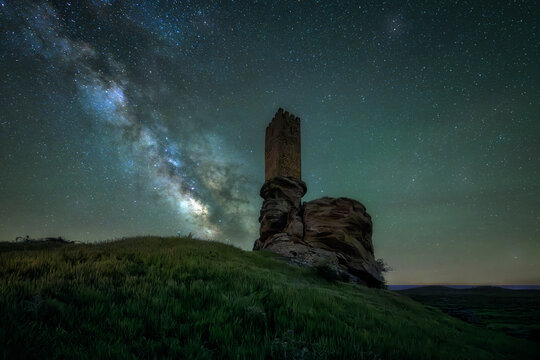 Ancient Zafra Castle in Spain, a medieval fortress silhouetted against a breathtaking Milky Way. Majestic night sky, stars and galaxy above historic ruins. Perfect for history, astronomy, travel