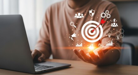 A person uses a laptop to plan business goals and marketing strategy