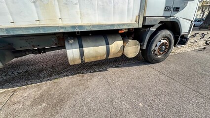 Rust-kissed industrial truck parked on cobblestone whispers of bygone travels, Diesel Daydreams...