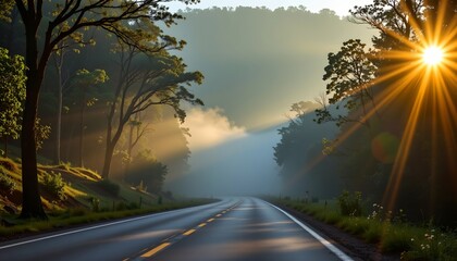 Fototapeta premium a serene forest road during sunrise or sunset. the sun shines brightly through the trees lining the winding road, creating a dramatic light effect