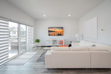 Modern living room with white sofa and tv screen