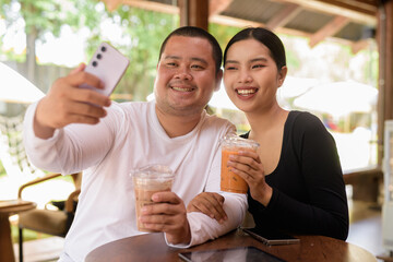 Happy young couple sitting in coffee shop