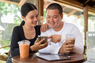 Happy young couple sitting in coffee shop