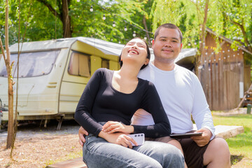 Couple camping in campground with their motorhome van car