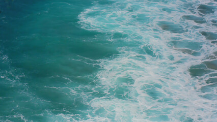 Turquoise Ocean Waves Crashing with Foamy Whitecaps, creating a dynamic and mesmerizing seascape.