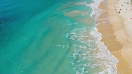 Aerial view of a tropical beach with turquoise water and golden sand, a serene seascape.