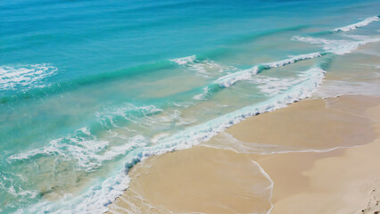 Aerial view of a beautiful beach with turquoise water and golden sand, creating a serene and inviting scene.