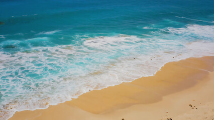 Aerial view of a beautiful beach with turquoise water and golden sand, creating a serene and inviting coastal scene.
