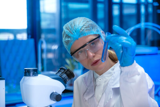 Female specialist medical laboratory scientist working with lab instrument for analyze diagnostic test of bodily in lab - Powered by Adobe