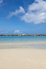 The beach at Mambo Beach, Curaçao and view of the breakwater off the coast.