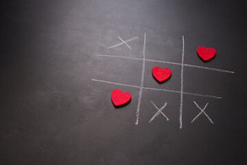 Tic-tac-toe game with red hearts symbolizing heart health on World Heart Day.