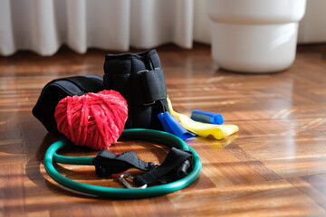 Fitness equipment with heart-shaped yarn symbolizing World Heart Day. Horizontal image. Copy space.