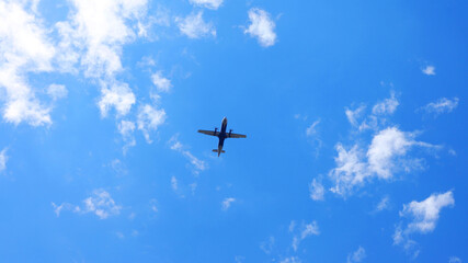 Piercing the sky, a propeller aircraft glides through the vast blue canvas, chasing horizons above...