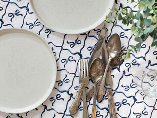 Top view of table place setting with handmade linens cutlery dishes dinner lunch meal prep
