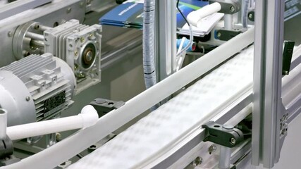 A conveyor belt in a factory for automated manufacturing - Powered by Adobe