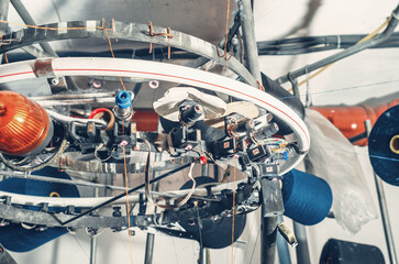 Thread tensioners located on spools on machines. Industrial enterprise for the production of socks....