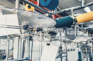 Thread tensioners located on spools on machines. Industrial enterprise for the production of socks....