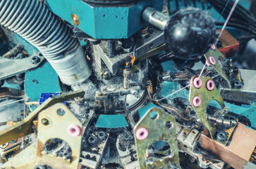 Industrial dust extraction. Exhaust pipe on an industrial knitting machine. Knitting factory mechanisms. Socks production.