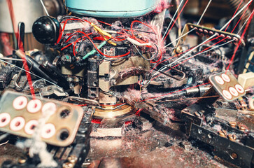 Lots of thread dust. Quality view of a sock knitting machine in operation. Machinery and equipment...