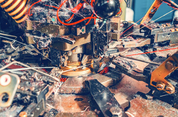 Close-up of knitting machine with cotton yarn in sock factory. Knitting machine with dust from the...