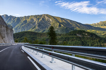 panoramic view of winding road through forested mountains. road trip and travel concept. transport and adventure-themed content