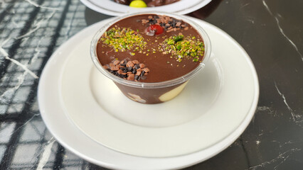 profiterole dessert in a plastic bowl on the table
