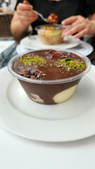 profiterole dessert in a plastic bowl on the table