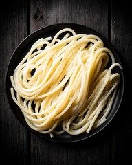 An overhead flat lay of an artisanal pasta dinner. The dark, moody lighting creates deep shadows, highlighting the rich textures of the food and the rustic, elegant table setting.

