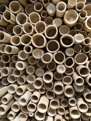 Circular bamboo sections stacked symmetrically, creating a natural textured wall.