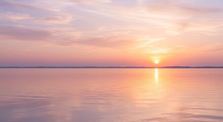 Naklejka premium Sunset Over Calm Water with Pink and Orange Sky at Dusk