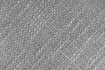 Close up, macro of gray woven fabric with detailed texture and diagonal pattern. Textile, cloth, material, fashion, upholstery, or abstract design background.