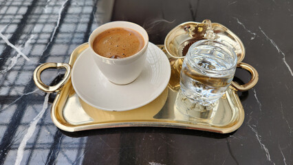Turkish coffee, water and Turkish delight on a gilded tray