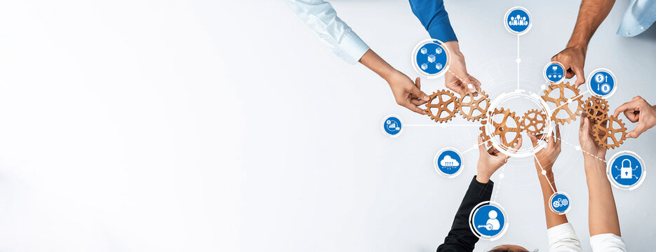 Dynamic image showcasing diverse hands collaborating around gears and digital icons to illustrate teamwork, innovation, and effective communication in a modern business setting. Amity