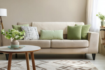 Elegant Scandinavian living room with cozy beige sofa and beautiful modern decor in soft color tones